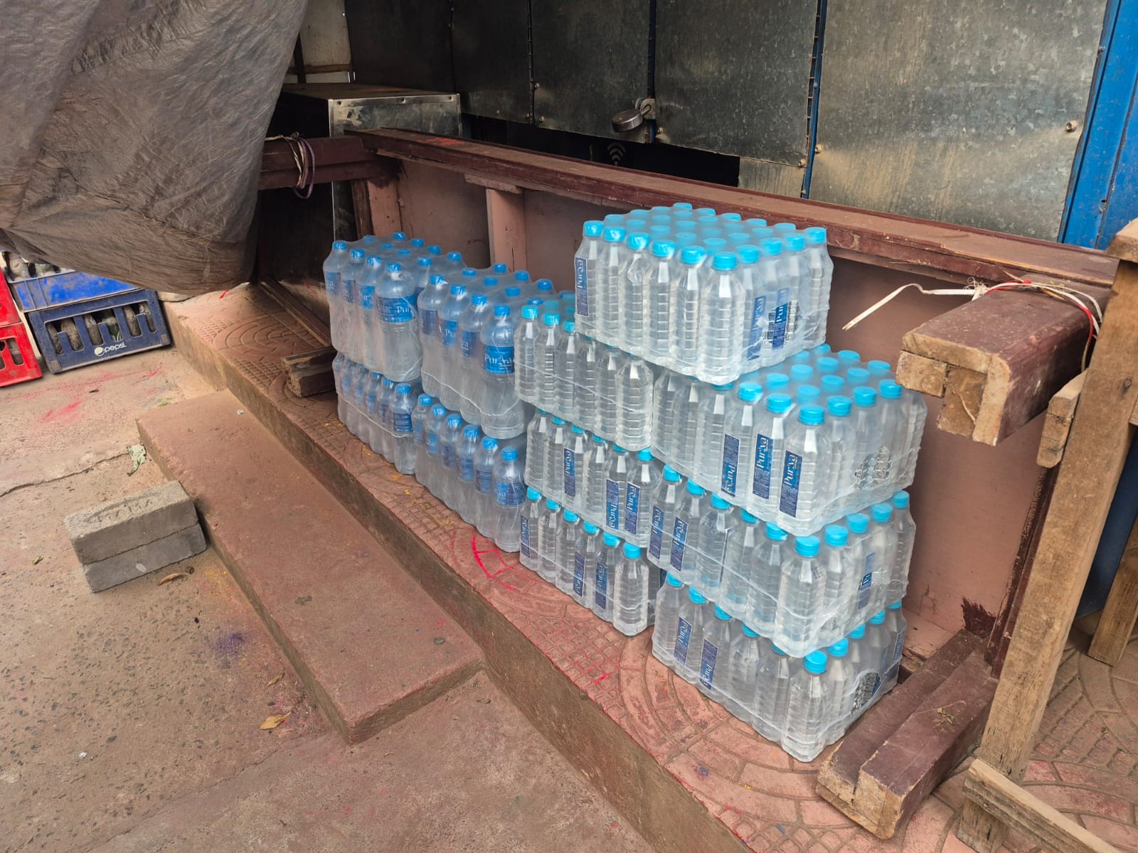 Puriva Water bottles displayed at a vendor stall